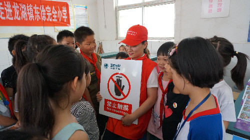 該公司黨員服務隊隊員孟姍姍在為孩子們講解安全標志
